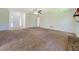 Open living area with neutral carpet, ceiling fan, and view of front door at 2811 Bay Leaf Se Dr, Conyers, GA 30094
