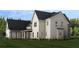 Rear view of the home showcasing white siding, a covered porch, and multiple windows at 6206 Cedarcrest Nw Rd, Acworth, GA 30101