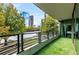 City view from balcony, with black metal railing and faux-grass flooring at 700 Park Regency Ne Pl # 603, Atlanta, GA 30326