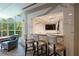 Wet bar with marble accents, TV, and barstool seating in a bright living space at 700 Park Regency Ne Pl # 603, Atlanta, GA 30326