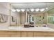Bright bathroom with double sink vanity, modern light fixture, and expansive mirror at 700 Park Regency Ne Pl # 603, Atlanta, GA 30326