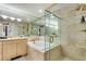Luxurious bathroom featuring a tub, a separate glass enclosed shower and neutral tiles at 700 Park Regency Ne Pl # 603, Atlanta, GA 30326