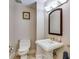 Classic bathroom with a pedestal sink, vintage-style fixtures, and a framed mirror at 700 Park Regency Ne Pl # 603, Atlanta, GA 30326