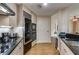Modern kitchen with stainless appliances, granite counters and a view into the adjacent living space at 700 Park Regency Ne Pl # 603, Atlanta, GA 30326