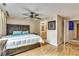Tranquil primary bedroom featuring a large decorative headboard and light wood flooring at 700 Park Regency Ne Pl # 603, Atlanta, GA 30326