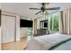 Relaxing bedroom features a dresser, ceiling fan and large window view at 700 Park Regency Ne Pl # 603, Atlanta, GA 30326