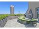 Luxury rooftop patio with ample seating, fireplace, and city views at 700 Park Regency Ne Pl # 603, Atlanta, GA 30326