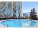 Outdoor pool with city views, surrounded by landscaping and high rise building at 700 Park Regency Ne Pl # 603, Atlanta, GA 30326