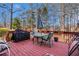 Red wooden deck features an outdoor grill, seating and table perfect for dining and relaxation at 3735 Holiday Lane Ln, Atlanta, GA 30349