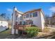 Back of home shows a deck with seating, trimmed hedges, and large windows providing lots of natural light at 3735 Holiday Lane Ln, Atlanta, GA 30349