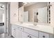 Bathroom vanity with double sinks, tile flooring and a framed mirror with vanity lighting at 3735 Holiday Lane Ln, Atlanta, GA 30349