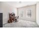 Bedroom features neutral carpet, two windows with wood blinds, and a desk with a dark wood finish at 3735 Holiday Lane Ln, Atlanta, GA 30349