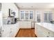 Bright kitchen with stainless appliances, white cabinets, tile backsplash, and hardwood floors at 3735 Holiday Lane Ln, Atlanta, GA 30349