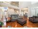 Bright living room featuring an open floor plan, hardwood floors, and a staircase to the second floor at 3735 Holiday Lane Ln, Atlanta, GA 30349