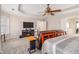 Comfortable main bedroom showcases a ceiling fan, TV, and a sitting area with a sofa and entertainment center at 3735 Holiday Lane Ln, Atlanta, GA 30349