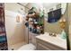 Small bathroom features a shower with white tiled walls, stacked towels and a modern sink at 600 Green Mountain Trl, College Park, GA 30349