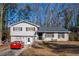 Charming home with a neat front yard and a bright red car in the driveway at 600 Green Mountain Trl, College Park, GA 30349