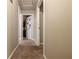 Hallway with neutral colored walls and carpet that provides access to multiple rooms at 600 Green Mountain Trl, College Park, GA 30349