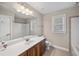 A bright bathroom featuring a vanity with a light-colored countertop and a combination shower-tub at 1502 Park Hollow Ln, Lawrenceville, GA 30043