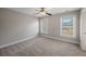 A bright bedroom featuring carpet floors, neutral paint, and two windows bringing in lots of natural light at 1502 Park Hollow Ln, Lawrenceville, GA 30043