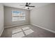 An empty bedroom featuring neutral paint, carpet, and a window bringing in lots of natural light at 1502 Park Hollow Ln, Lawrenceville, GA 30043