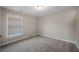 A carpeted bedroom features neutral walls, a window with blinds, and a flush mount light at 1502 Park Hollow Ln, Lawrenceville, GA 30043