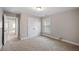 This carpeted bedroom has neutral walls, a window with blinds, and a double-door closet at 1502 Park Hollow Ln, Lawrenceville, GA 30043