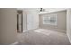 A bedroom featuring neutral walls, carpet floors, ceiling fan, and natural light from the large window at 1502 Park Hollow Ln, Lawrenceville, GA 30043