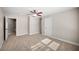 A spacious bedroom with carpet floors and neutral walls lit by natural light from the window at 1502 Park Hollow Ln, Lawrenceville, GA 30043