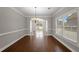 Dining room features hardwood floors, crown molding, and a chandelier at 1502 Park Hollow Ln, Lawrenceville, GA 30043