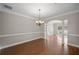 Dining room features hardwood floors, classic chandelier, and decorative columns at 1502 Park Hollow Ln, Lawrenceville, GA 30043