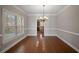 Dining room with hardwood floors, crown molding, and a classic chandelier at 1502 Park Hollow Ln, Lawrenceville, GA 30043