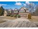 Inviting brick home with a two-car garage and a well-manicured front lawn on a sunny day at 1502 Park Hollow Ln, Lawrenceville, GA 30043