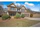 Charming two-story brick home features a well-manicured lawn and an attached two-car garage at 1502 Park Hollow Ln, Lawrenceville, GA 30043