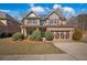 Beautiful two-story brick home features a well-maintained lawn and an attached two-car garage at 1502 Park Hollow Ln, Lawrenceville, GA 30043