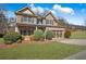 Charming two-story brick home features a well-manicured lawn and an attached two-car garage at 1502 Park Hollow Ln, Lawrenceville, GA 30043