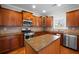 Modern kitchen featuring stainless steel appliances, granite countertops, wooden cabinets, and a center island at 1502 Park Hollow Ln, Lawrenceville, GA 30043