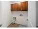 A utility area with tile floors and cabinets over the washer and dryer connections at 1502 Park Hollow Ln, Lawrenceville, GA 30043