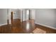 Spacious living room featuring gleaming hardwood floors and neutral wall colors at 1502 Park Hollow Ln, Lawrenceville, GA 30043