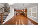 Open-concept living space featuring hardwood floors, a staircase, and a view into the modern kitchen at 1502 Park Hollow Ln, Lawrenceville, GA 30043