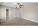 A main bedroom with soft carpeting, neutral colored walls, and a ceiling fan at 1502 Park Hollow Ln, Lawrenceville, GA 30043