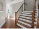 Elegant staircase with wooden steps and wrought iron railings, leading to the upper levels of the home at 1502 Park Hollow Ln, Lawrenceville, GA 30043