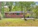 Large, grassy backyard with a brick home in the background at 2150 Meadowlane Dr, Atlanta, GA 30311