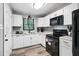 Modern kitchen featuring white cabinets, stainless steel appliances, and granite countertops at 2150 Meadowlane Dr, Atlanta, GA 30311