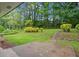 Expansive backyard featuring lush greenery, mature trees, and a small patio, perfect for outdoor relaxation at 2478 Graywall St, Atlanta, GA 30344