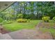 Spacious backyard featuring a patio, lush lawn, mature trees, and landscape, perfect for outdoor relaxation at 2478 Graywall St, Atlanta, GA 30344