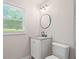 A bathroom featuring updated vanity, modern fixtures and large window at 2478 Graywall St, Atlanta, GA 30344