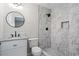 A bathroom featuring updated vanity, modern fixtures and tiled standing shower at 2478 Graywall St, Atlanta, GA 30344