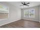 Spacious bedroom with wood floors, plenty of natural light from large windows and modern ceiling fan at 2478 Graywall St, Atlanta, GA 30344