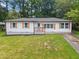 Charming home featuring a well-maintained lawn, white siding, wood shutters, and a cozy front porch at 2478 Graywall St, Atlanta, GA 30344